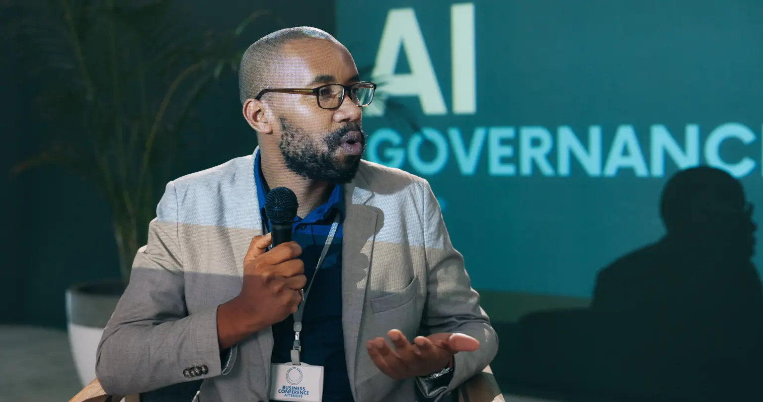 black man speaking at conference